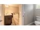Bathroom featuring a double sink vanity, framed mirror and tiled shower with glass door at 254 Cappella Ct, New Smyrna Beach, FL 32168