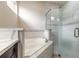 Bathroom featuring a soaking tub, glass enclosed shower, and neutral tiling, offering a spa-like retreat at 254 Cappella Ct, New Smyrna Beach, FL 32168