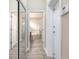 Hallway view of a tiled bathroom featuring a separate glass enclosed shower and corner soaking tub at 254 Cappella Ct, New Smyrna Beach, FL 32168