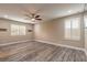 Spacious bedroom with wood-look flooring, ceiling fan, and windows with plantation shutters at 254 Cappella Ct, New Smyrna Beach, FL 32168