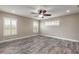 Spacious bedroom featuring wood-look flooring, neutral paint, and multiple windows with plantation shutters at 254 Cappella Ct, New Smyrna Beach, FL 32168