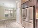 Cozy breakfast nook next to stainless steel refrigerator and bright window with shutters at 254 Cappella Ct, New Smyrna Beach, FL 32168