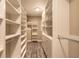 Spacious walk-in closet featuring custom shelves, drawers and hanging storage at 254 Cappella Ct, New Smyrna Beach, FL 32168