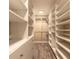 Walk-in closet with built-in shelving, drawers, and hanging rods for optimal storage at 254 Cappella Ct, New Smyrna Beach, FL 32168