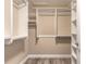Walk-in closet with custom shelving and wood-look tile flooring providing ample storage space at 254 Cappella Ct, New Smyrna Beach, FL 32168