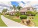 Beautiful two-story home with manicured lawn, lush landscaping, and palm trees, creating an inviting curb appeal at 254 Cappella Ct, New Smyrna Beach, FL 32168