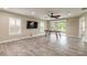 Spacious game room with hardwood flooring, ceiling fan, recessed lights, and sliding glass doors at 254 Cappella Ct, New Smyrna Beach, FL 32168
