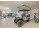 Spacious garage with epoxy flooring, storage, a golf cart, and space for recreational equipment at 254 Cappella Ct, New Smyrna Beach, FL 32168