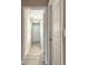 Bright hallway features wood-look tile flooring and natural light streaming through shuttered windows at 254 Cappella Ct, New Smyrna Beach, FL 32168