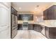 Modern kitchen with stainless steel appliances, white countertops, and wood-look floors at 254 Cappella Ct, New Smyrna Beach, FL 32168