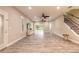 Spacious living room with wood-look tile, recessed lighting, ceiling fans, and a staircase at 254 Cappella Ct, New Smyrna Beach, FL 32168
