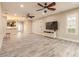 Well lit, open floor plan features tile floor, TV, a staircase, plus views of kitchen and front entryway at 254 Cappella Ct, New Smyrna Beach, FL 32168