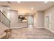 Bright open floor plan with wood-look tile, staircase, and an eat-in kitchen and bar area at 254 Cappella Ct, New Smyrna Beach, FL 32168