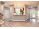 Open floor plan with wood-look tile, and eat-in kitchen and bar area. Great natural light at 254 Cappella Ct, New Smyrna Beach, FL 32168