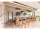 Covered outdoor bar area with seating, TV, cabinets, counter space, and a shower at 254 Cappella Ct, New Smyrna Beach, FL 32168