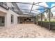 Enclosed patio featuring brick pavers, ceiling fans, and an outdoor bar area for entertaining at 254 Cappella Ct, New Smyrna Beach, FL 32168