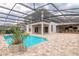 Back of house shows covered bar area with a sparkling blue in-ground pool at 254 Cappella Ct, New Smyrna Beach, FL 32168