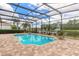 Beautiful screened in pool overlooking a peaceful lake with fountain at 254 Cappella Ct, New Smyrna Beach, FL 32168