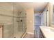 Tiled shower with glass door, rain shower head, and built-in niche in a bright bathroom at 254 Cappella Ct, New Smyrna Beach, FL 32168