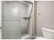 Modern tiled shower with glass doors, a rainfall showerhead, and a built-in shelf at 254 Cappella Ct, New Smyrna Beach, FL 32168