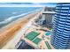 Scenic aerial view showcasing the condo's pool, tennis courts, beachfront access, and proximity to the ocean at 2625 S Atlantic Ave # 18Nw, Daytona Beach, FL 32118