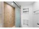 Tiled shower with glass door in bathroom featuring a toilet and a towel rack at 2625 S Atlantic Ave # 18Nw, Daytona Beach, FL 32118