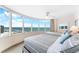 Bright bedroom with two beds, waterfront views, and a ceiling fan at 2625 S Atlantic Ave # 18Nw, Daytona Beach, FL 32118