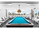 Billiards room with a pool table, windows offering ocean views, and ample seating at 2625 S Atlantic Ave # 18Nw, Daytona Beach, FL 32118