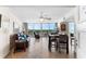 Cozy living room with comfortable seating, dining area, and a seamless transition to the outdoor balcony at 2625 S Atlantic Ave # 18Nw, Daytona Beach, FL 32118