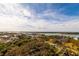 An aerial view showcases the neighborhood surrounded by lush foliage and tranquil waters at 265 Minorca Beach Way # 902, New Smyrna Beach, FL 32169
