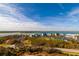 An aerial view of a waterfront community with multiple low-rise buildings and beautiful blue skies at 265 Minorca Beach Way # 902, New Smyrna Beach, FL 32169