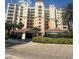 Front exterior of 265 Minorca Beach Way condominium building with covered parking and lush landscaping at 265 Minorca Beach Way # 902, New Smyrna Beach, FL 32169