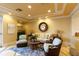 Cozy living room with stylish furnishings, including a sofa, chairs, and a decorative round mirror at 265 Minorca Beach Way # 902, New Smyrna Beach, FL 32169