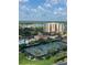 Scenic view of tennis courts, swimming pool, and lush landscaping with the ocean in the background at 265 Minorca Beach Way at 265 Minorca Beach Way # 902, New Smyrna Beach, FL 32169