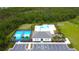 Aerial view of the community pool, pickleball court, parking lot, and playground at 2818 Taton Trce, New Smyrna Beach, FL 32168