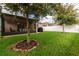 Well-maintained backyard with a covered patio, green lawn, and white picket fence at 2818 Taton Trce, New Smyrna Beach, FL 32168