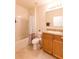 Bright bathroom features a tub, a vanity with tan countertop, and neutral tile at 2818 Taton Trce, New Smyrna Beach, FL 32168