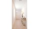 Inviting hallway showcases neutral tile flooring and a decorative console table with a lamp at 2818 Taton Trce, New Smyrna Beach, FL 32168
