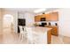 Kitchen featuring wood cabinets, stainless steel sink, and a breakfast bar with white stools at 2818 Taton Trce, New Smyrna Beach, FL 32168