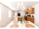 Bright kitchen with wood cabinets, stainless steel sink, breakfast bar and dining table at 2818 Taton Trce, New Smyrna Beach, FL 32168