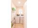 Efficient laundry room with washer, dryer, shelving, and storage basket at 2818 Taton Trce, New Smyrna Beach, FL 32168