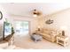 Bright living room features a comfortable sofa, ceiling fan and sliding doors to the outdoor space at 2818 Taton Trce, New Smyrna Beach, FL 32168