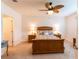 Bedroom features a patterned bedspread, ceiling fan, and bedside tables with lamps at 2818 Taton Trce, New Smyrna Beach, FL 32168