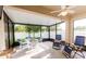 Enclosed outdoor patio featuring a dining set, lounge chairs, and serene views of the backyard at 2818 Taton Trce, New Smyrna Beach, FL 32168