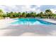 Relaxing community pool surrounded by lush landscaping and lounge chairs at 2818 Taton Trce, New Smyrna Beach, FL 32168
