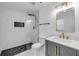 Modern bathroom with a glass shower, hexagon tile, and vanity with gold fixtures at 2822 Brookline Ave, New Smyrna Beach, FL 32168