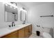 Modern bathroom features double sinks with wood cabinets and black fixtures at 2822 Brookline Ave, New Smyrna Beach, FL 32168