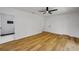 Spacious bedroom features wood-look flooring, a ceiling fan, and an ensuite bathroom at 2822 Brookline Ave, New Smyrna Beach, FL 32168