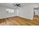 Bright bedroom features wood-look flooring, a ceiling fan, and an exterior door at 2822 Brookline Ave, New Smyrna Beach, FL 32168