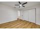 This bedroom features wood-look flooring, a ceiling fan, and a double-door closet at 2822 Brookline Ave, New Smyrna Beach, FL 32168